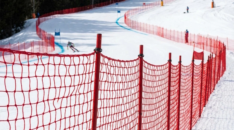 skiers on a super-g race track